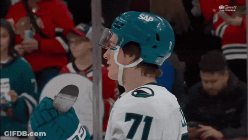 A Hockey Player Wearing A Blue Sap Helmet GIF