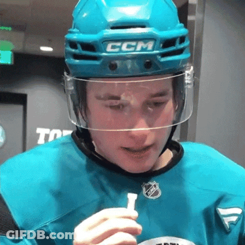 A Hockey Player Wearing A Ccm Helmet Holds A Stick GIF