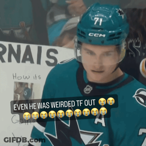 A Hockey Player Wearing A Ccm Helmet Stands In Front Of A Sign That Says Rnais GIF