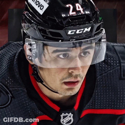 A Hockey Player Wearing A Ccm Helmet With The Number 24 On It GIF