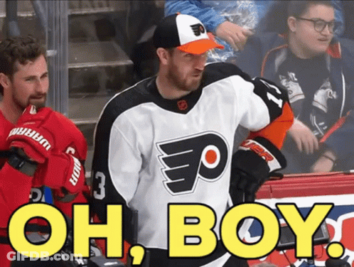 A Hockey Player Wearing A Flyers Jersey Stands In Front Of A Sign That Says Oh Boy GIF
