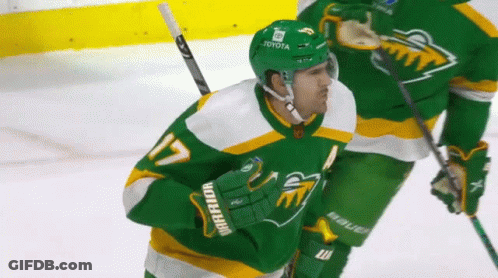 A Hockey Player Wearing A Green Jersey That Says Warrior GIF
