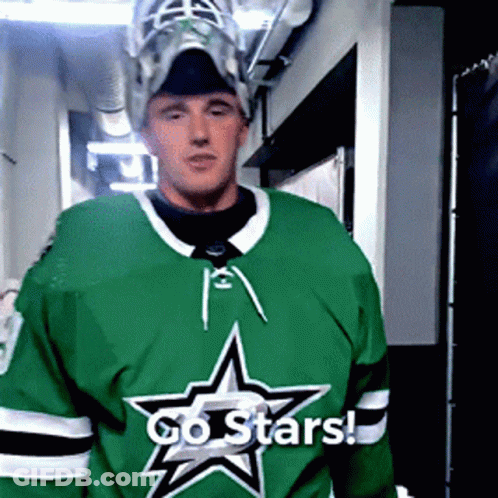 A Hockey Player Wearing A Green Jersey With A Star On It Says Go Stars GIF