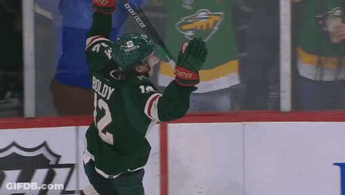 A Hockey Player Wearing A Green Jersey With Boldy On The Back GIF