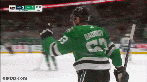 A Hockey Player Wearing A Green Jersey With Daddy On It GIF