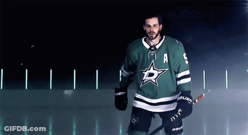 A Hockey Player Wearing A Green Jersey With The Letter A On The Front GIF