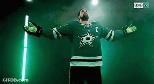 A Hockey Player Wearing A Green Jersey With The Letter C On The Front GIF