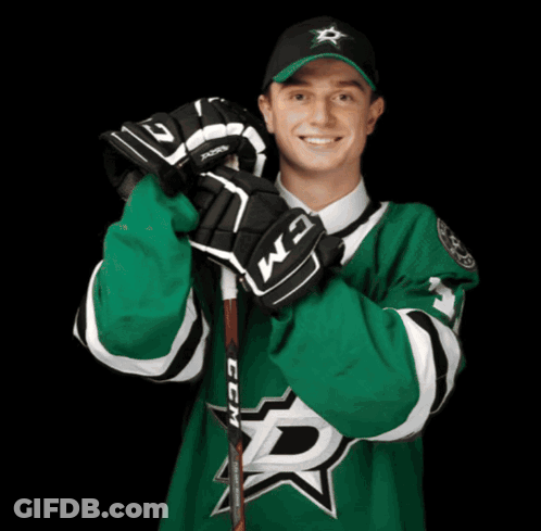 A Hockey Player Wearing A Green Jersey With The Letter D On The Front GIF