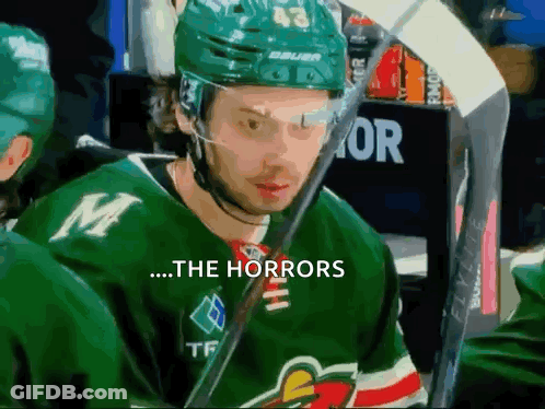 A Hockey Player Wearing A Green Jersey With The Letter M On The Front GIF