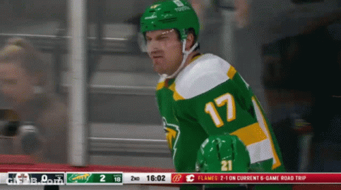 A Hockey Player Wearing A Green Jersey With The Number 17 GIF