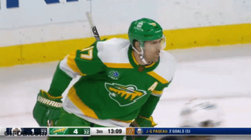 A Hockey Player Wearing A Green Jersey With The Number 17 On It GIF
