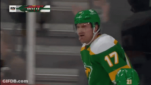 A Hockey Player Wearing A Green Jersey With The Number 17 GIF