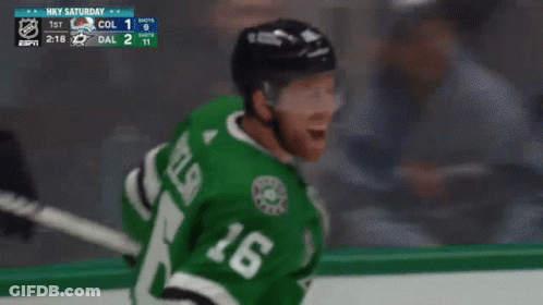 A Hockey Player Wearing A Green Jersey With The Number 18 On It GIF