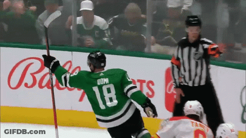 A Hockey Player Wearing A Green Jersey With The Number 18 On It GIF