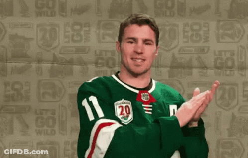 A Hockey Player Wearing A Green Jersey With The Number 20 On It GIF