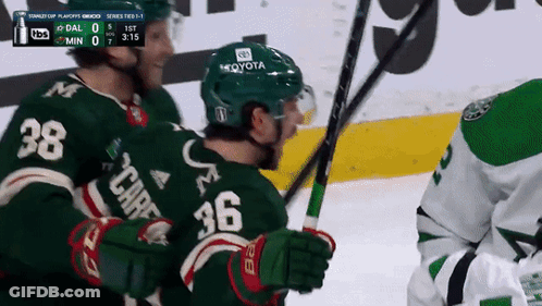 A Hockey Player Wearing A Green Jersey With The Number 36 On The Back GIF
