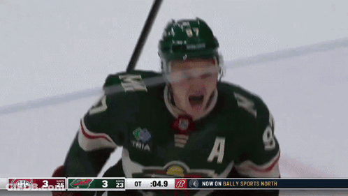 A Hockey Player Wearing A Green Jersey With The Number 8 On It GIF