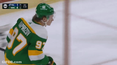 A Hockey Player Wearing A Green Jersey With The Number 97 GIF