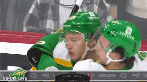 A Hockey Player Wearing A Green Toyota Helmet GIF
