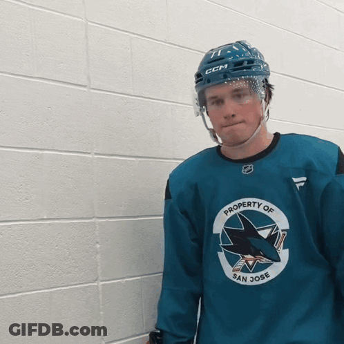 A Hockey Player Wearing A Helmet And A Jersey That Says Property Of San Jose GIF