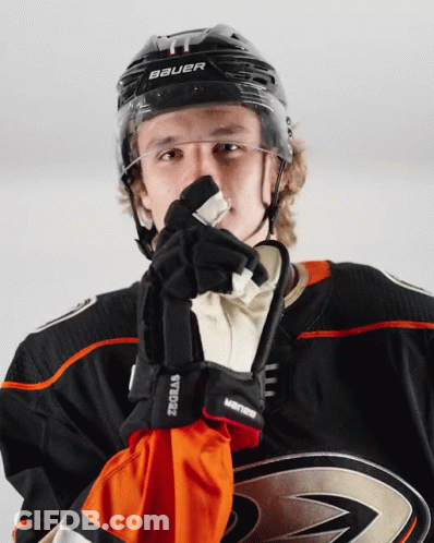 A Hockey Player Wearing A Helmet And Gloves With The Word Bauer On It GIF