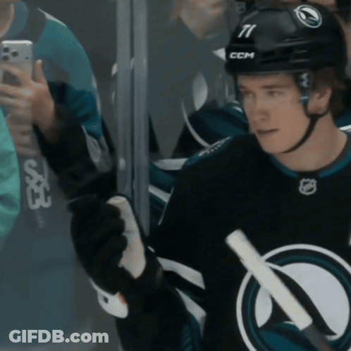 A Hockey Player Wearing A Helmet With The Number 11 On It GIF
