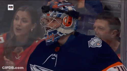 A Hockey Player Wearing A Helmet With The Word Oilers On The Front GIF