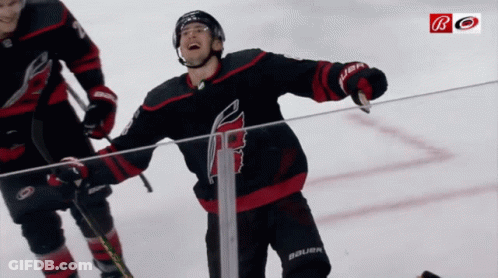 A Hockey Player Wearing A Jersey That Says Bauer Is Standing On The Ice GIF