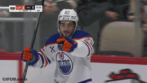 A Hockey Player Wearing A Jersey That Says Oilers On It GIF
