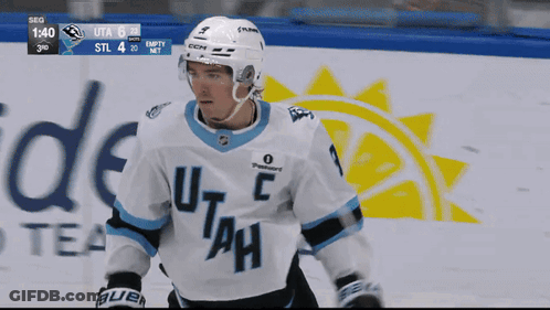 A Hockey Player Wearing A Jersey That Says Utah GIF