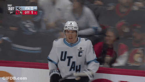 A Hockey Player Wearing A Jersey That Says Utah GIF