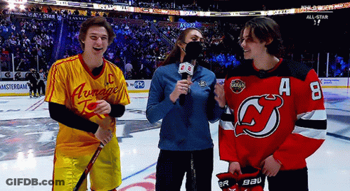 A Hockey Player Wearing A Jersey With The Letter A On It Talks To A Reporter GIF