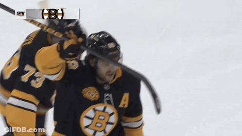 A Hockey Player Wearing A Jersey With The Letter B On The Front GIF