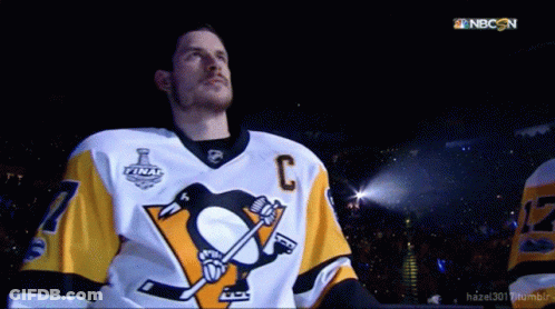 A Hockey Player Wearing A Jersey With The Letter C On The Front GIF