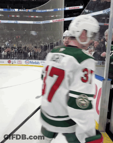 A Hockey Player Wearing A Jersey With The Number 37 On It GIF