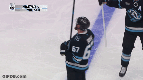 A Hockey Player Wearing A Jersey With The Number 67 GIF