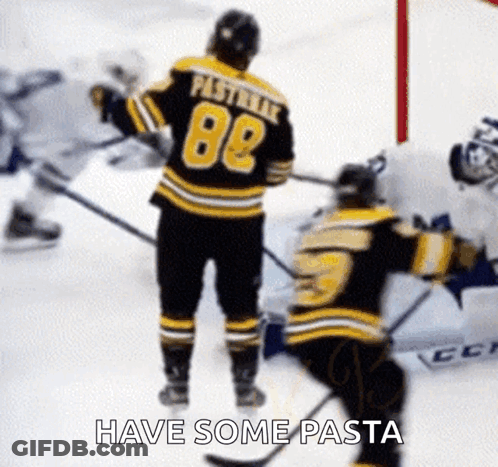A Hockey Player Wearing A Jersey With The Number 88 Is Standing On The Ice Next To Another Hockey Player . GIF