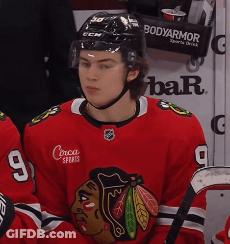 A Hockey Player Wearing A Jersey With The Number 9 On It GIF