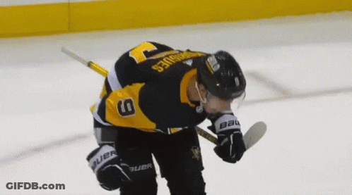 A Hockey Player Wearing A Jersey With The Number 9 On It GIF