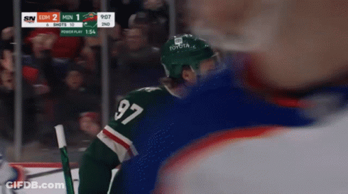 A Hockey Player Wearing A Jersey With The Number 97 GIF