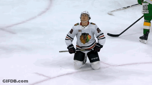 A Hockey Player Wearing A Jersey With The Number 98 On It GIF