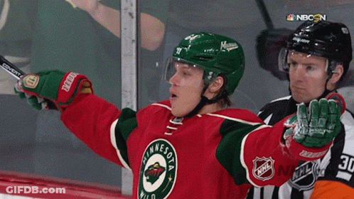 A Hockey Player Wearing A Minnesota Wild Jersey Holds Up His Arms GIF