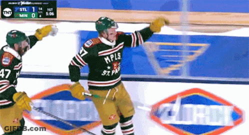 A Hockey Player Wearing A Mpls Jersey Celebrates A Goal GIF