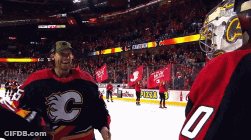 A Hockey Player Wearing A Number 0 Jersey Stands On The Ice GIF