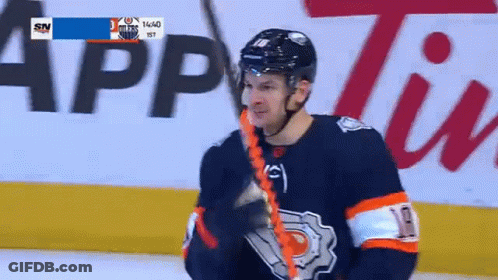 A Hockey Player Wearing A Number 10 Jersey Is Holding A Hockey Stick GIF