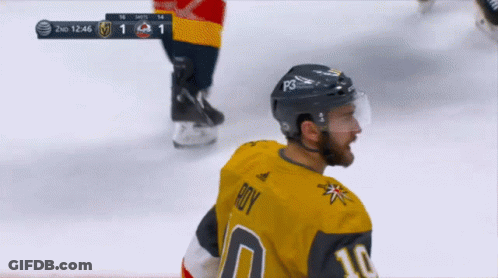 A Hockey Player Wearing A Number 10 Jersey Stands On The Ice GIF