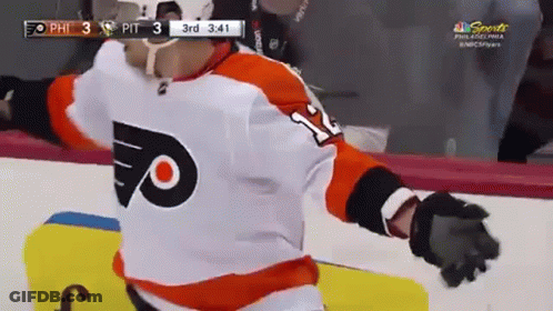 A Hockey Player Wearing A Number 11 Jersey Is Standing On The Ice GIF