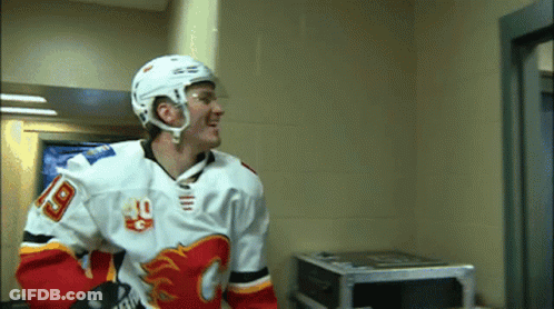 A Hockey Player Wearing A Number 18 Jersey GIF