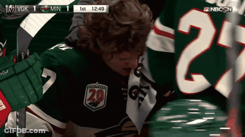 A Hockey Player Wearing A Number 20 Jersey GIF