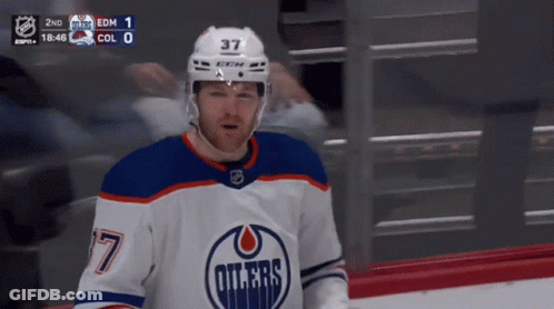 A Hockey Player Wearing A Number 37 Jersey GIF